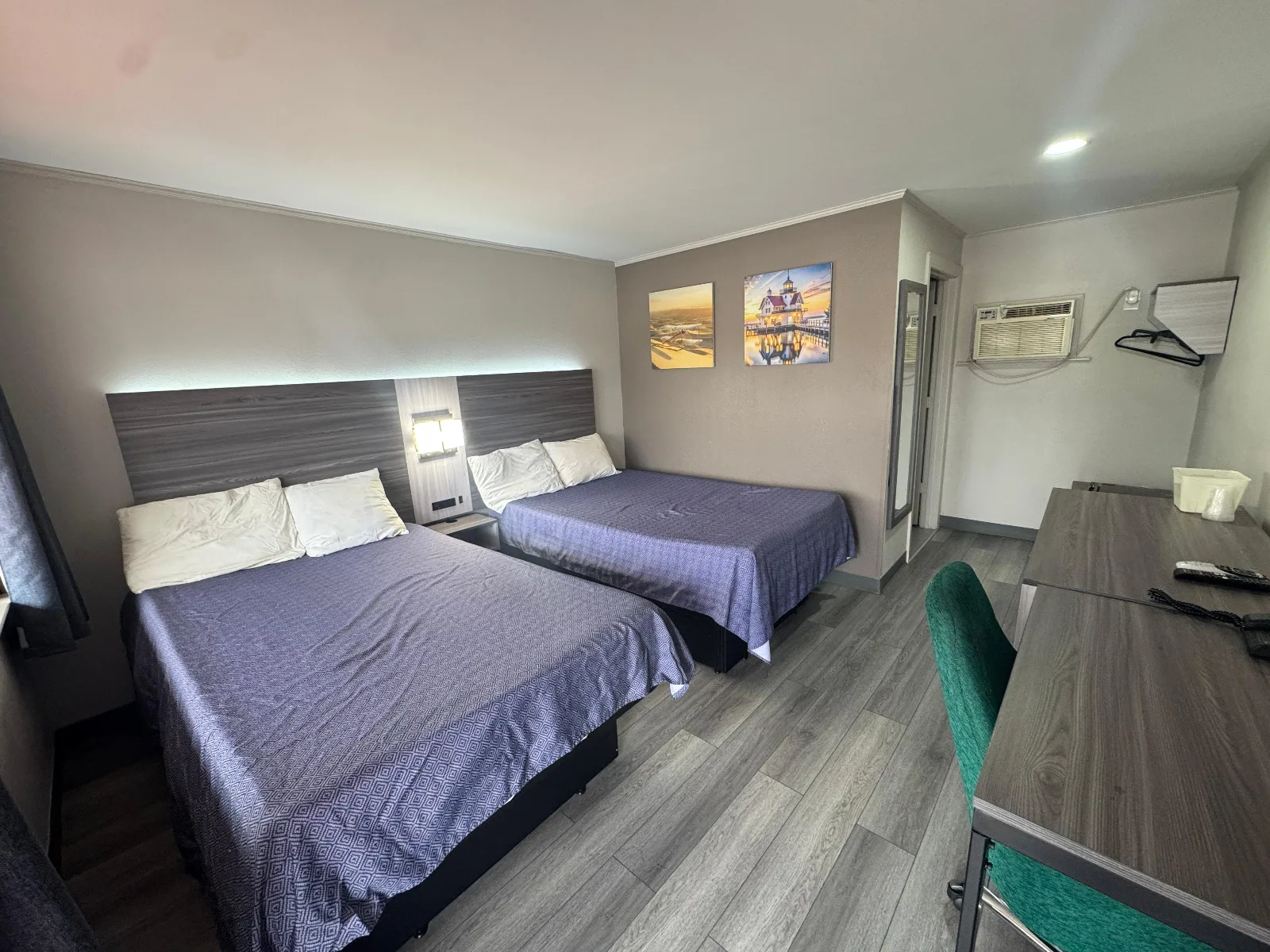 Spacious double full bedroom with two beds, desk, and modern amenities at Sportsman Inn