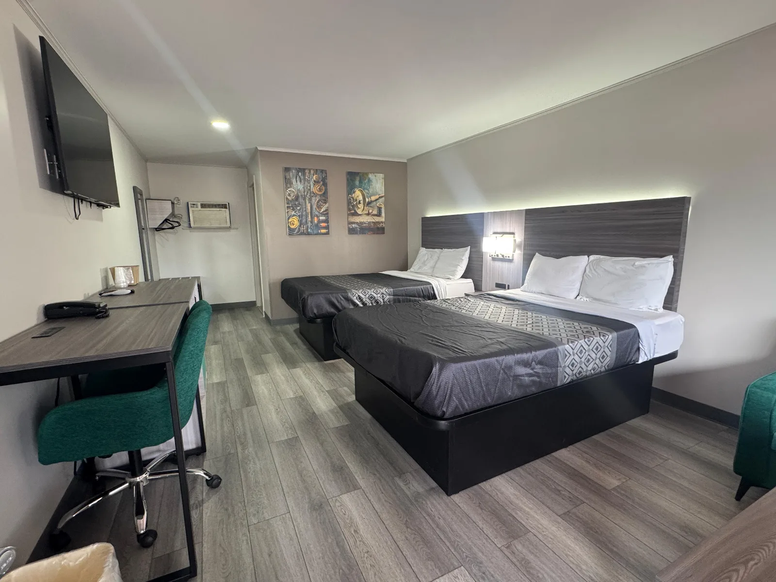 Double room with two queen beds, work desk, desk chair and flat-screen TV at Sportsman Inn