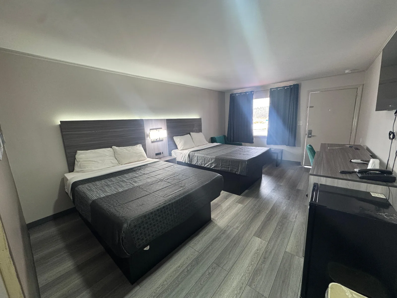 Superior Double Queen Room with two queen beds and modern amenities at Sportsman Inn
