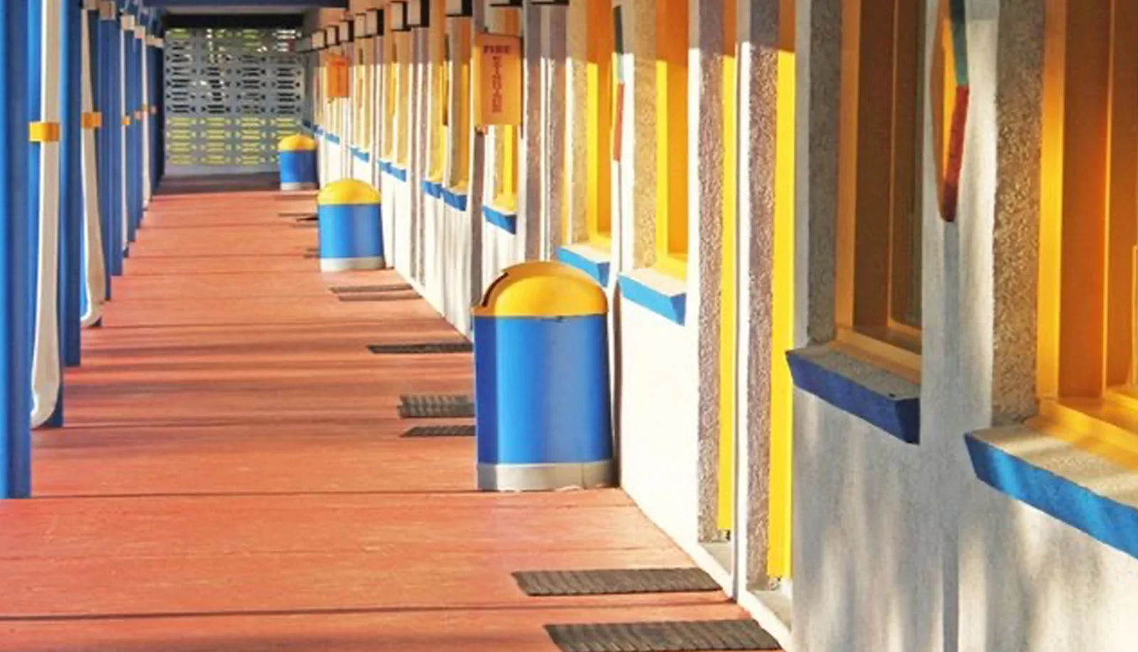 Colorful beach hut-style hallway with blue and yellow accents at Sportsman Inn